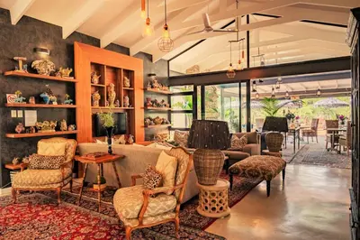 a living room with a couch and chairs at Safari Moon Luxury Bush Lodge in Hoedspruit