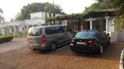two cars parked in front of a house at Heatherdale Guesthouse & Shuttle Services in Pretoria