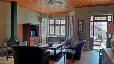 a living room with a couch and a table at Bluebell Country House in Dullstroom
