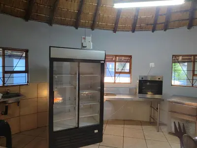a kitchen with an empty refrigerator in a room at Graskop family retreat and backpackers in Graskop