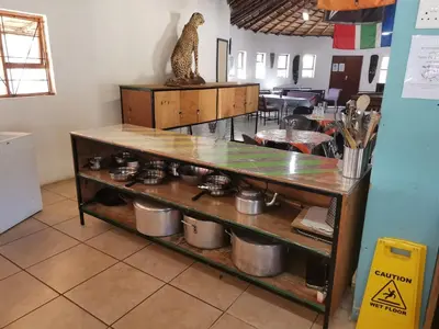 a kitchen with a counter with pots and pans at Graskop family retreat and backpackers in Graskop