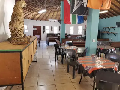 a restaurant with a leopard statue sitting on the counter at Graskop family retreat and backpackers in Graskop