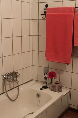 a bathroom with a tub and a red towel at Jocks Cottages in Dullstroom