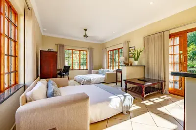 a bedroom with a bed and a couch at Country Lane Lodge in White River