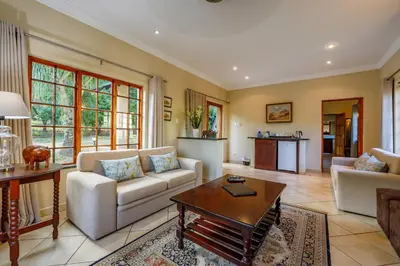 a living room with a couch and a table at Country Lane Lodge in White River