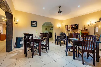 a dining room with wooden tables and chairs at Country Lane Lodge in White River