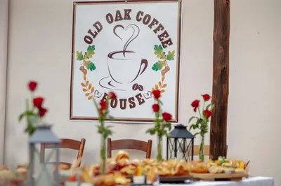 a table with plates of food and a sign with a coffee cup at Oregon Place Guest House in Middelburg
