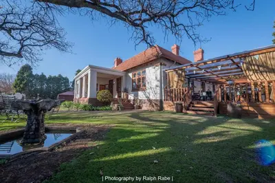 an exterior view of a house with a yard at Oregon Place Guest House in Middelburg