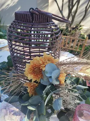 a basket with flowers on top of a table at Oregon Place Guest House in Middelburg