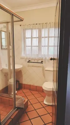 a bathroom with a toilet and a sink at Oregon Place Guest House in Middelburg