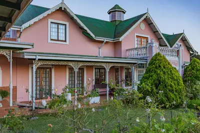 a pink house with a green roof at Westlodge at Graskop B&B in Graskop