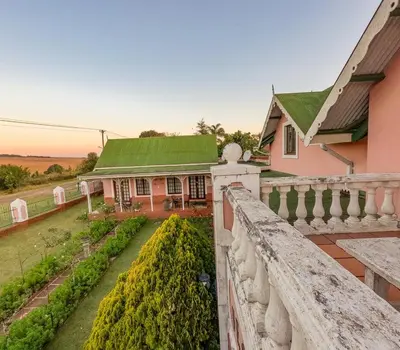 a house with a green roof and a garden at Westlodge at Graskop B&B in Graskop