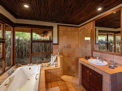 a bathroom with a tub and a sink at Tintswalo Waterberg in Vaalwater