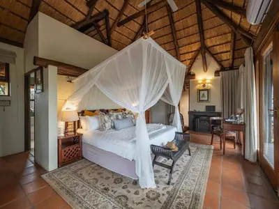 a bedroom with a bed with a canopy at Tintswalo Waterberg in Vaalwater