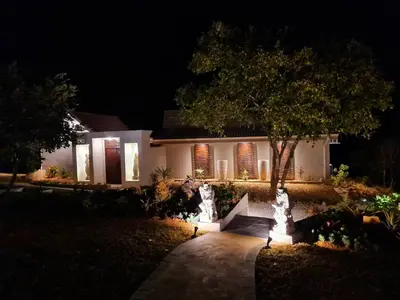 a house at night with lights in the yard at The Zarafa in Hazyview