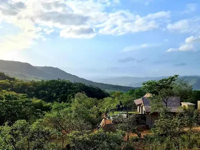a house on a hill with mountains in the background at The Zarafa in Hazyview