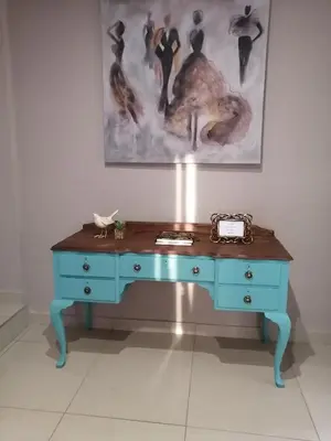 a blue desk in a room with a painting on the wall at Shai's Nest in Centurion