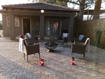 a brick patio with chairs and a fire hydrant at Shai's Nest in Centurion