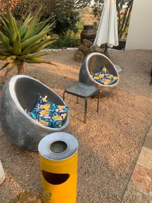 two bath tubs and a chair on the ground at JB Countrylife Accommodation in Koedoe