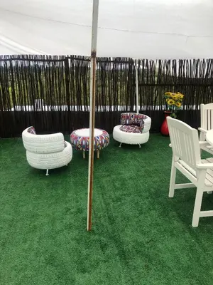 a group of chairs and an umbrella on the grass at JB Countrylife Accommodation in Koedoe