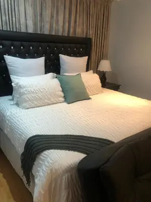 a bedroom with a large bed with white pillows at JB Countrylife Accommodation in Koedoe