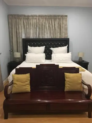 a bedroom with a large bed with white pillows at JB Countrylife Accommodation in Koedoe