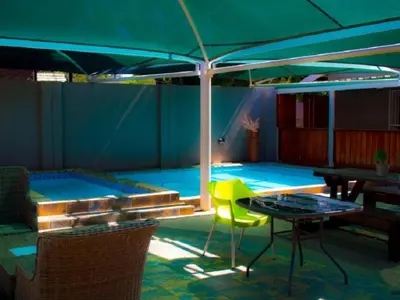 a patio with a table and a swimming pool at Monacco Guest house in Erasmus