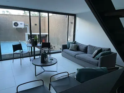 a living room with a couch and a table at Ten On Lane in Polokwane