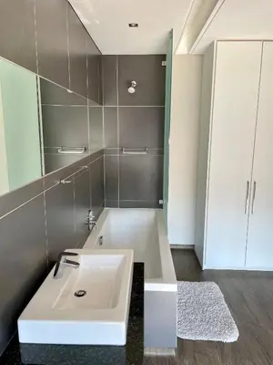a bathroom with a white sink and a mirror at Ten On Lane in Polokwane