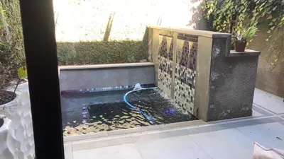 a fish tank with a hose in a backyard at Ten On Lane in Polokwane