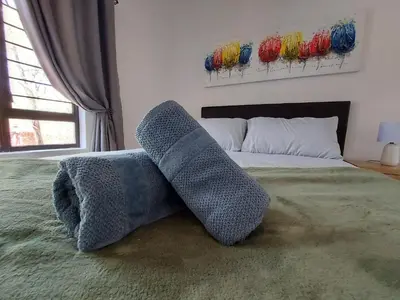 a bedroom with a bed with two socks on it at 3714 @Ribbok in Marloth Park