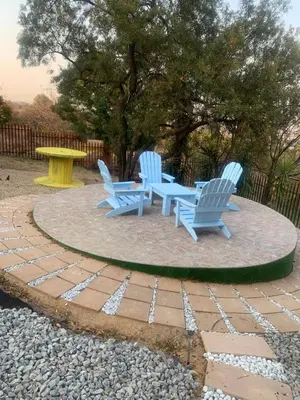 two blue chairs and a table on a patio at JB Countrylife Accommodation in Centurion