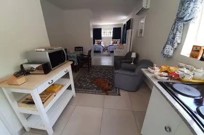 a kitchen and living room with a counter top and a living room at Kruger Southern Cross in Malelane