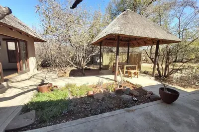 a gazebo with a table and chairs in a yard at 13 Raptors Lodge in Hoedspruit