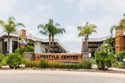 a sign in front of aecycle centre with palm trees at #Alimama Spaces Blyde Haven in Pretoria