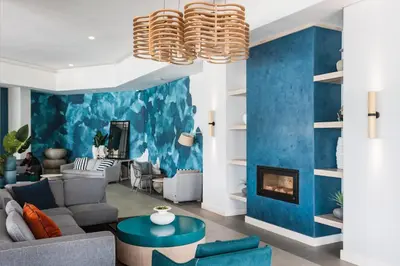 a living room with blue walls and a fireplace at #Alimama Spaces Blyde Haven in Pretoria