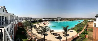 a large swimming pool with umbrellas and a beach at #Alimama Spaces Blyde Haven in Pretoria