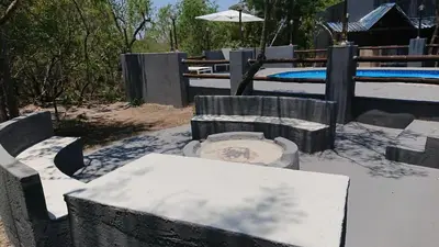 a playground with a table and an umbrella at SVH Bush Lodge in Marloth Park