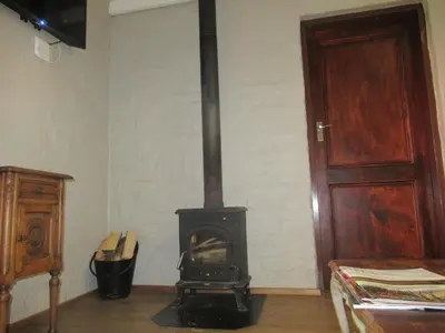 a black stove in a room with a door at Critchley Hackle - Leisure rooms in Dullstroom