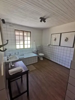 a bathroom with a tub and a sink and a toilet at Critchley Hackle - Leisure rooms in Dullstroom