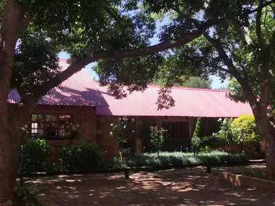 a building with a red roof at Critchley Hackle - Leisure rooms in Dullstroom