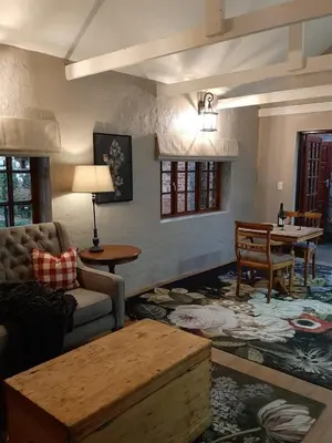 a living room with a couch and a table at Critchley Hackle - Leisure rooms in Dullstroom