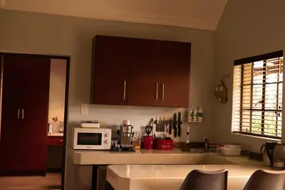 a kitchen with a counter top with a microwave at Camdeboo Place in Dullstroom