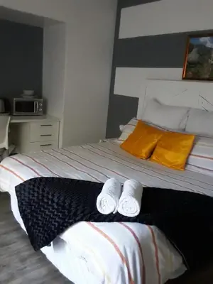 a bedroom with a bed with two towels on it at Lior-Gil accommodation- in Kempton Park