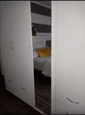 a mirror reflecting a bedroom with a bed in a room at Lior-Gil accommodation- in Kempton Park