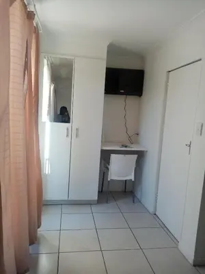 a room with a desk and a table in a room at Lior-Gil accommodation- in Kempton Park