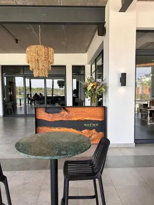 a table and chairs in a lobby with a chandelier at 1152 @The Blyde Riverwalk - Crystal Lagoon in Pretoria