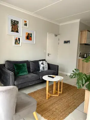 a living room with a couch and a table at 1152 @The Blyde Riverwalk - Crystal Lagoon in Pretoria