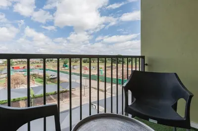 a balcony with a view of a pool at Alimama Spaces: The Manson's Green Creek in Pretoria