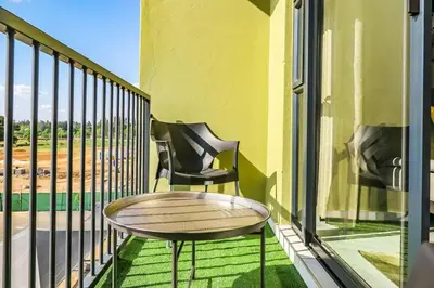 a balcony with two chairs and a table at Alimama Spaces: The Manson's Green Creek in Pretoria